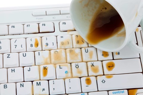 Cup of coffee spilled on a computer keyboard. Damage for insurance, Cup of coffee spilled on a