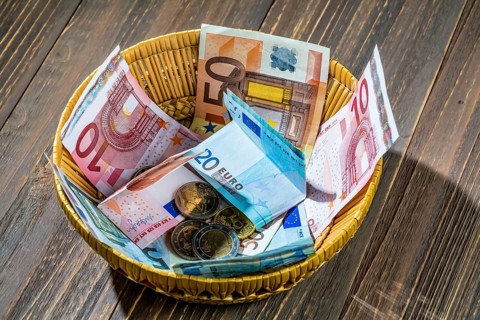 A basket with money for donations and tips Austria