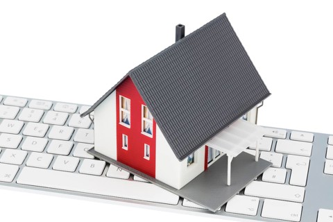House on keyboard, symbolic photo for buying and renting a house via the Internet