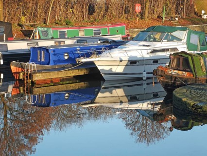 Old narrow boats converted to houseboats moored in the marina at brighouse basin in west yorkshire