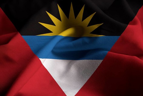 Ruffled Flag of Antigua and Barbuda Blowing in Wind