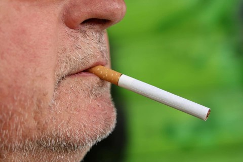 Man with a cigarette in his mouth