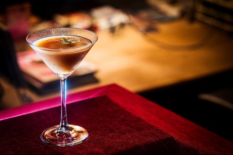 Chocolate and cream martini in cozy bar at night