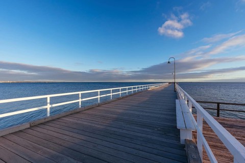 Kerford Rd Pier and Albert Park Yachting Angling Club in Albert Park at sunset on a winter's