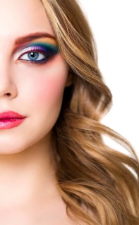 Close up portrait of a beautiful young blond model with bright make up. Close up of abstract