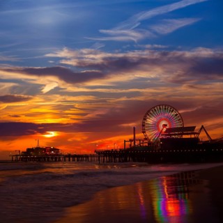 Santa Monica California sunset on Pier Ferrys wheel and reflection on beach wet sand