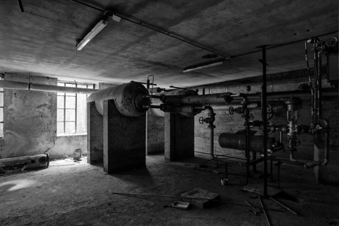 A picture of some abandoned pipes and valves