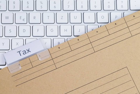 The photo shows a white keyboard with a tax briefcase