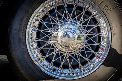 Lisbon, Portugal, Jan 20, 2024: Car design detail of Jaguar chrome wire wheel, stainless steel