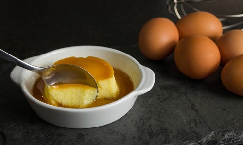 Traditional Brazilian dessert, milk pudding on dark background