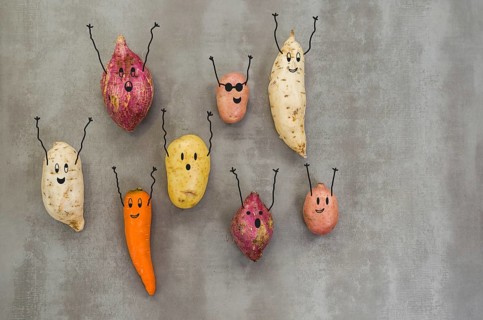Great concept of healthy eating, vegetables with happy faces with arms up, potato, sweet potato,