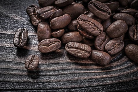 Coffee beans on vintage wood board food and drink concept