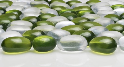Artificial round stones of green and white color. imitation pebbles