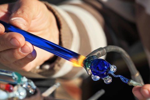 Delicate work of the glass blower. On a photo hands of the master are visible. The Artist-glass