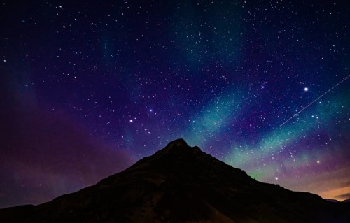 Of Iceland Aurora and mountain silhouette. Shooting Location: Iceland, Reykjavik