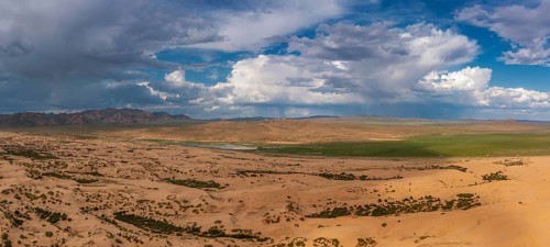 Aerial panorama view of the sand dunes Elsen Tasarhai (Bayan Gobi) desert and mountains in Mongolia