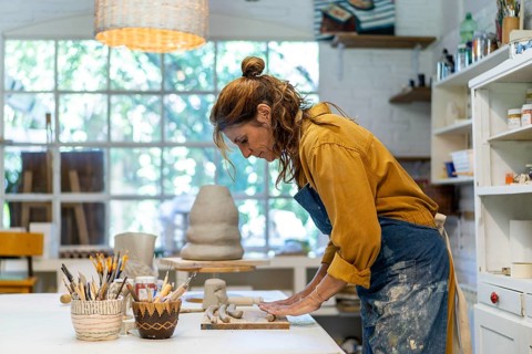Woman artist crafting with clay and care