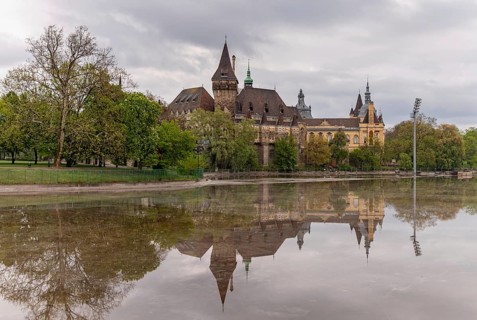 A picture of the Vajdahunyad Castle reflected on the City Park Lake