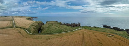 Slains Castle, castle ruins on the cliffs, drone shot, Cruden Bay, Peterhead, Aberdeenshire,