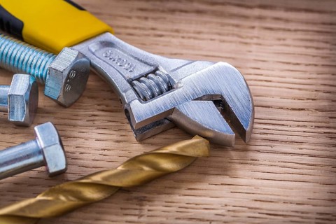 Composition screws adjustable wrench drill and bolt On Wooden Board