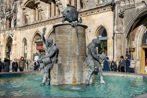 Fish fountain on Marienplatz in front of the New Town Hall in neo-Gothic style, Munich, Upper