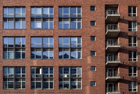 House facade in hamburg's Speicherstadt - reflection in the windows of the elbphilharmonie concert