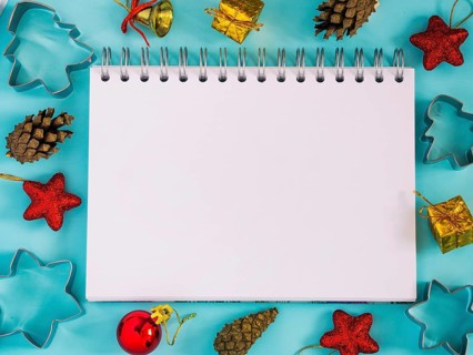 Christmas background with blank notebook, decorations. Copy space. Top view or flat lay. Toned