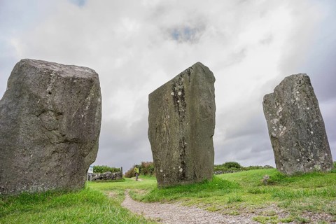 Woman observing the menhirs, Megalithic Circle of Drombeg, The Altar of the Druid-, Rosscarbery