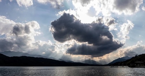 Cloudy mood over Lake Millstättersee, sunbeams from clouds, near Millstatt, Carinthia. Austria
