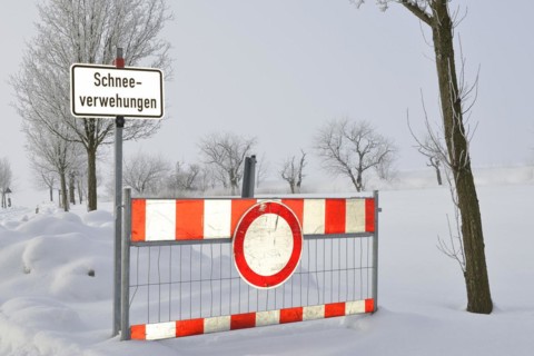 Road blockage through snow drifts. Blocked road