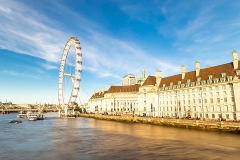 The London Eye on the South Bank of the River Thames at night in London, England. Europe