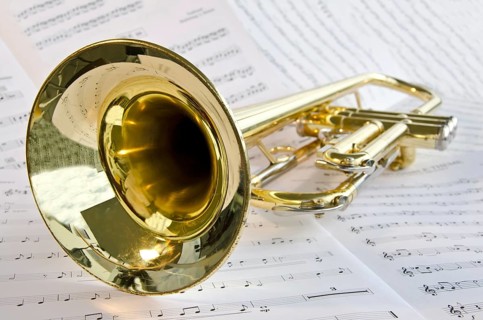 Closeup of trumpet lying on sheet music