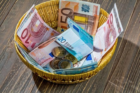 A basket with money for donations and tips Austria