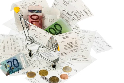Shopping trolleys, banknotes and receipts, symbolising purchasing power, consumption and inflation