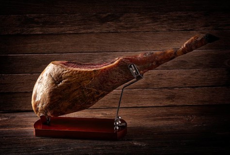 Iberian ham pata negra from Spain on wood background