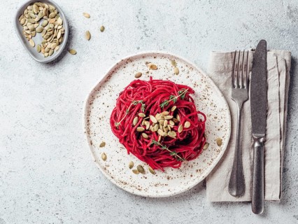 Beetroot pesto or hummus. Homemade beet pesto sauce in glass jar and fresh thyme on dark black