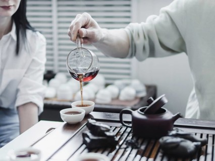 Chinese tea ceremony. Master pouring puer tea in cups. Pu erh tea ceremony