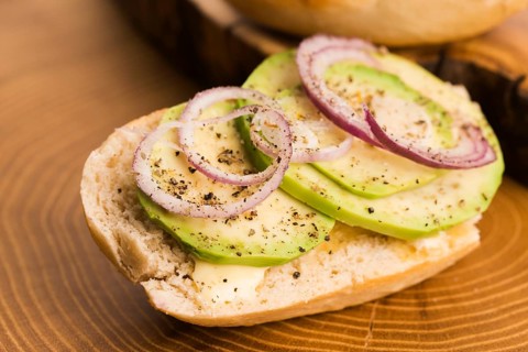 Sandwich with avocado, red onion, salt and herbs