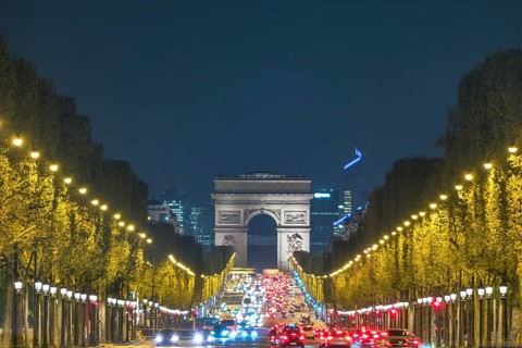 Paris France night city skyline at Arc de Triomphe and Champs Elysees