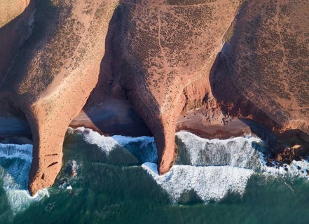 Aerial top view on Legzira beach with arched rocks on the Atlantic coast at sunset in Morocco