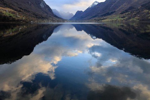 View of the Innvikfjorden near Loen in Norway. The landscape is reflected in the water