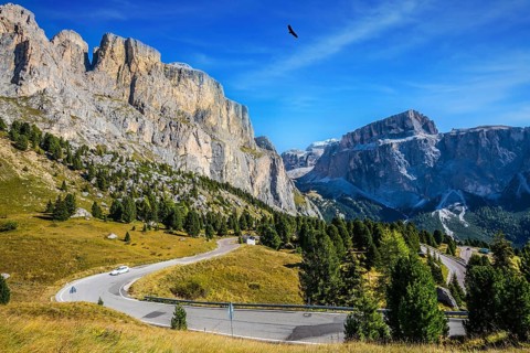 Picturesque road through the Sella Pass, Dolomites. The concept of extreme and ecological tourism.