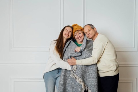 Close up portrait of family with elderly mature woman, man and millennial daughter.