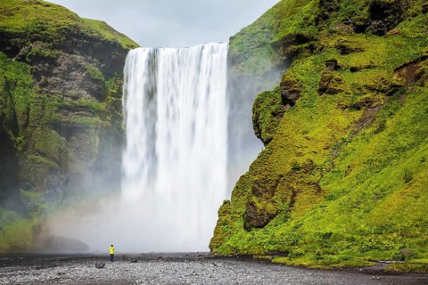 Magnificent famous waterfall Skógafoss, Iceland. A powerful jet Skógar River forms a large rainbow