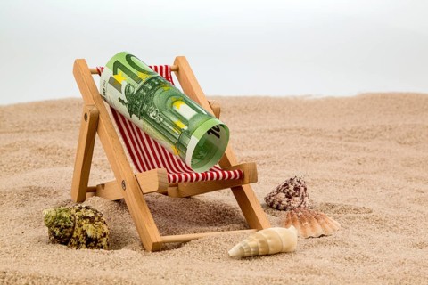 A deckchair with a euro banknote. Symbolic photo for saving on holiday and when travelling Austria