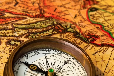 An old compass lies on a map of Austria