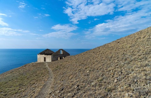 Old ruined house on the hillside above the sea. Crimea, Cape Meganom