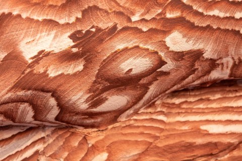 Multi-colored sandstone rock and mineral layers in ancient tombs of Petra, Jordan. Pattern,
