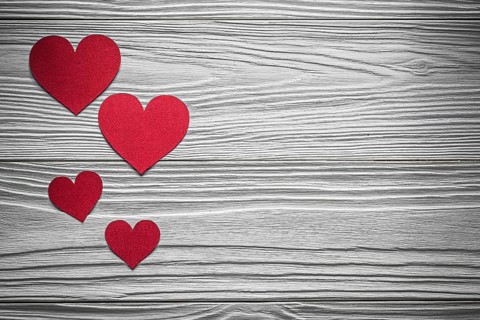 Red paper hearts on wooden board Valentine cards