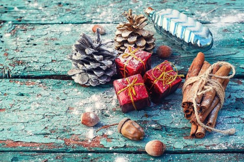 Christmas decorations, cone, cinnamon and nuts on wooden background